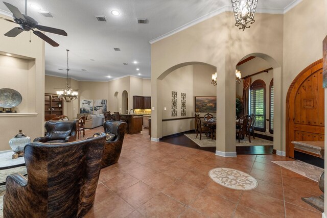 4022 Hidden Winds Dr, Spring, TX 77386 - living room with arched walkways, ceiling fan, a chandelier, tile patterned flooring, and baseboards