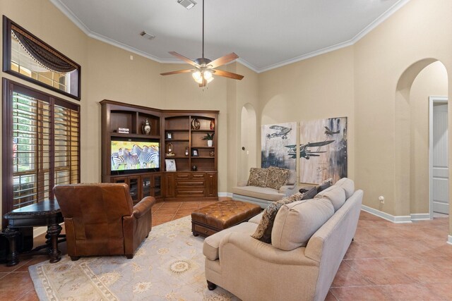 4022 Hidden Winds Dr, Spring, TX 77386 - living room with arched walkways, ornamental molding, light tile patterned floors, ceiling fan, and a towering ceiling