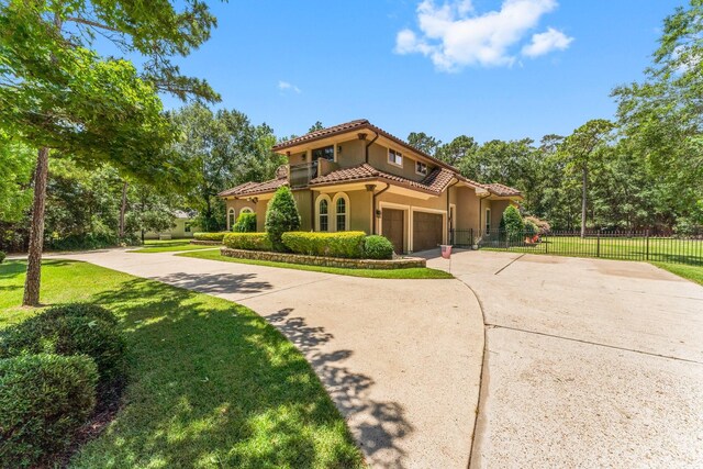 4022 Hidden Winds Dr, Spring, TX 77386 - mediterranean / spanish-style house with stucco siding, driveway, and a tile roof