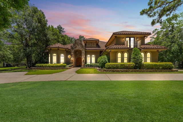 4022 Hidden Winds Dr, Spring, TX 77386 - mediterranean / spanish-style house featuring a tiled roof, stucco siding, a front lawn, and a balcony