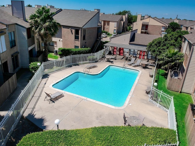 3220 69th St Unit B8, Galveston, TX 77551 - community pool with a patio area, a residential view, and a fenced backyard