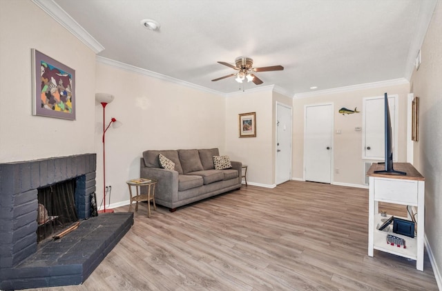 3220 69th St Unit B8, Galveston, TX 77551 - living room featuring a ceiling fan, wood finished floors, crown molding, baseboards, and a brick fireplace