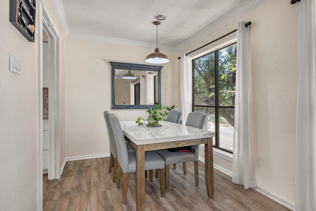 3220 69th St Unit B8, Galveston, TX 77551 - dining space with crown molding, wood finished floors, and baseboards
