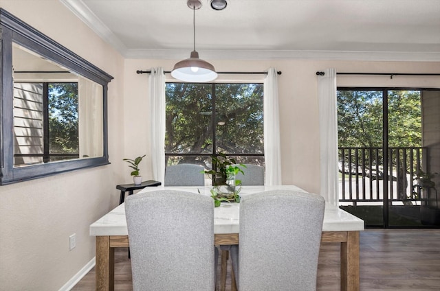 3220 69th St Unit B8, Galveston, TX 77551 - dining area featuring plenty of natural light, wood finished floors, crown molding, and baseboards