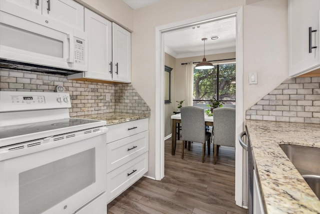 3220 69th St Unit B8, Galveston, TX 77551 - kitchen with white appliances, white cabinetry, decorative backsplash, ornamental molding, and dark wood-style flooring