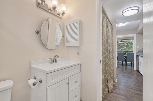 3220 69th St Unit B8, Galveston, TX 77551 - bathroom featuring vanity, wood finished floors, and toilet
