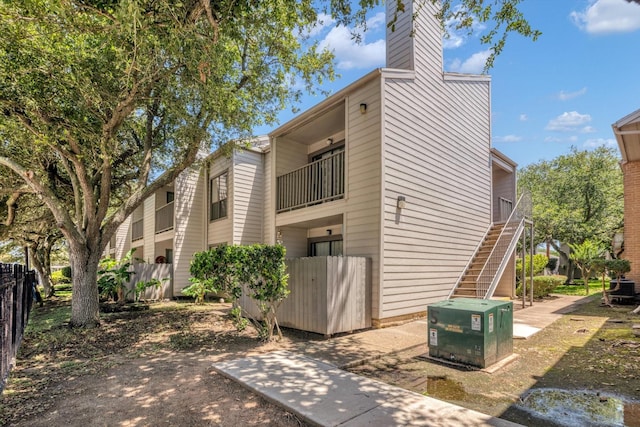 3220 69th St Unit B8, Galveston, TX 77551 - view of side of home with stairs and a chimney