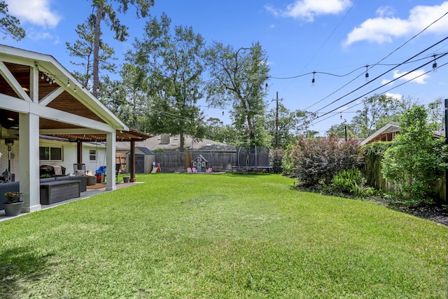 10207 Chatterton Dr, Houston, TX 77043 - view of yard featuring an outdoor hangout area, a trampoline, and a patio area