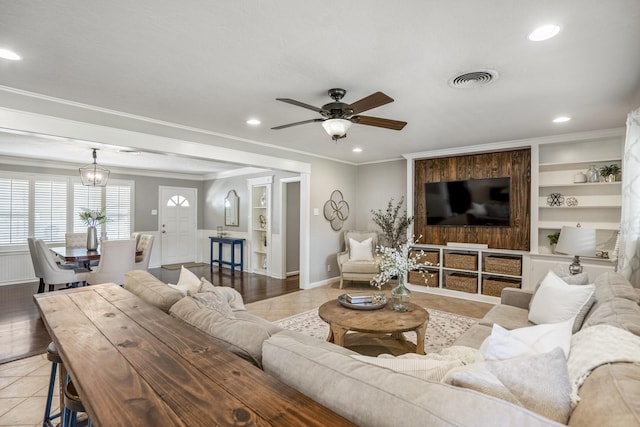10207 Chatterton Dr, Houston, TX 77043 - living room featuring a ceiling fan, light tile patterned floors, built in shelves, recessed lighting, and crown molding