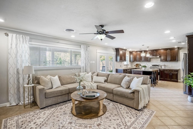 10207 Chatterton Dr, Houston, TX 77043 - living area with light tile patterned floors, ceiling fan, recessed lighting, crown molding, and baseboards