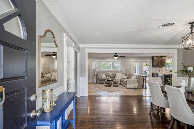 10207 Chatterton Dr, Houston, TX 77043 - dining room with ceiling fan, wood finished floors, ornamental molding, a chandelier, and a textured ceiling