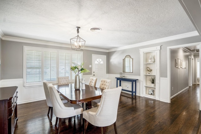 10207 Chatterton Dr, Houston, TX 77043 - dining room with a textured ceiling, built in shelves, a chandelier, dark wood-style flooring, and wainscoting