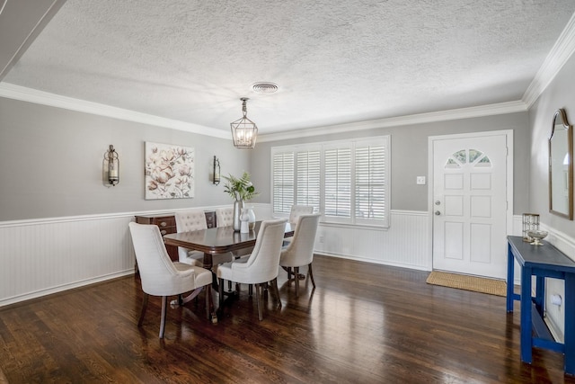 10207 Chatterton Dr, Houston, TX 77043 - dining room with a wainscoted wall, a textured ceiling, a chandelier, wood finished floors, and ornamental molding