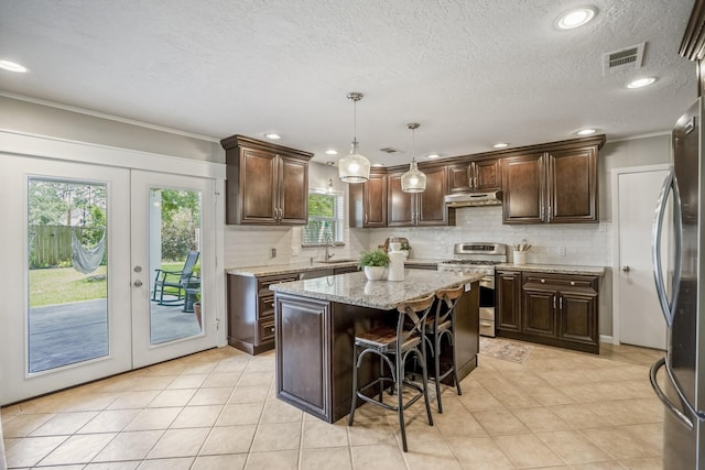 10207 Chatterton Dr, Houston, TX 77043 - kitchen featuring appliances with stainless steel finishes, dark brown cabinets, tasteful backsplash, crown molding, and french doors