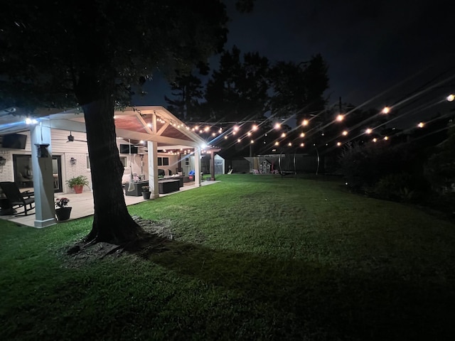 10207 Chatterton Dr, Houston, TX 77043 - yard at twilight featuring a covered hot tub, a patio area, and a lawn