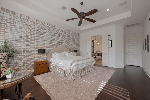 7 Edgemont Ct, Fulshear, TX 77441 - bedroom with a tray ceiling, dark wood-type flooring, brick wall, baseboards, and recessed lighting