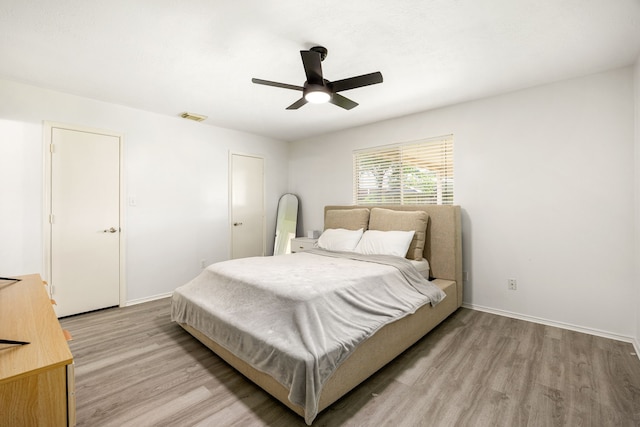 3107 Snug Harbour Ct, Katy, TX 77449 - bedroom with light wood-type flooring, baseboards, and ceiling fan