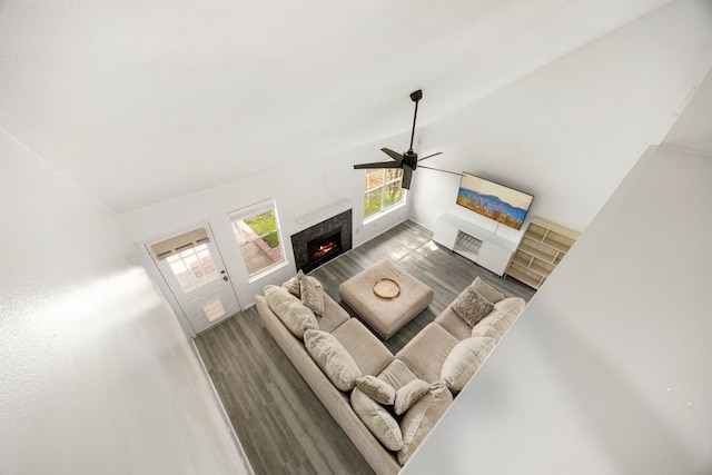 3107 Snug Harbour Ct, Katy, TX 77449 - living area with a premium fireplace, ceiling fan, vaulted ceiling, and wood finished floors