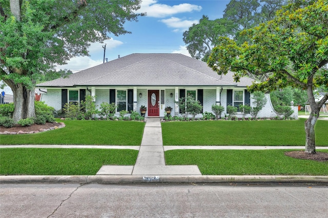 963 Thornton Rd, Houston, TX 77018 - view of front of property featuring a front lawn, brick siding, roof with shingles, and covered porch