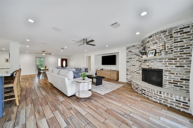 963 Thornton Rd, Houston, TX 77018 - living area featuring ceiling fan, a brick fireplace, wood finished floors, recessed lighting, and crown molding