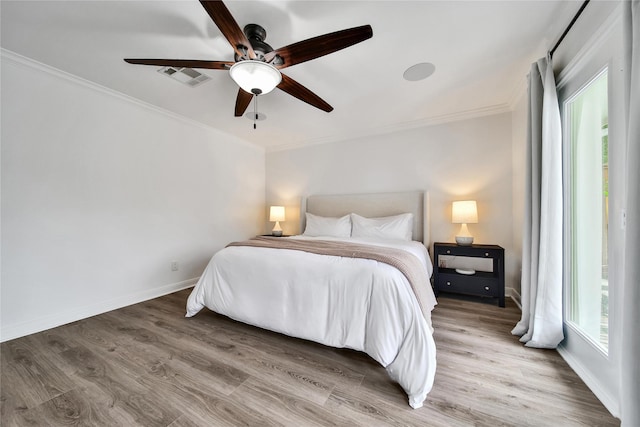 963 Thornton Rd, Houston, TX 77018 - bedroom with crown molding, wood finished floors, baseboards, and a ceiling fan