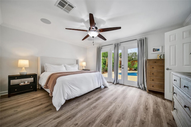 963 Thornton Rd, Houston, TX 77018 - bedroom with access to exterior, ornamental molding, wood finished floors, and a ceiling fan