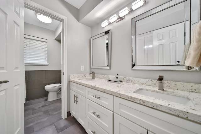 963 Thornton Rd, Houston, TX 77018 - bathroom with double vanity, tile patterned flooring, tile walls, and toilet