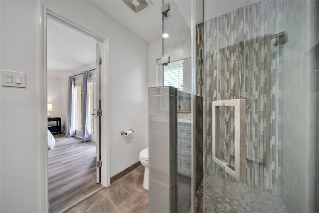 963 Thornton Rd, Houston, TX 77018 - bathroom featuring tiled shower, toilet, marble finish flooring, and baseboards