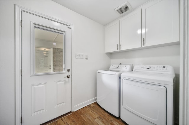 963 Thornton Rd, Houston, TX 77018 - washroom with separate washer and dryer, cabinet space, dark wood-style floors, and baseboards