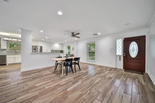 963 Thornton Rd, Houston, TX 77018 - dining room with ceiling fan, light wood-style flooring, recessed lighting, crown molding, and baseboards
