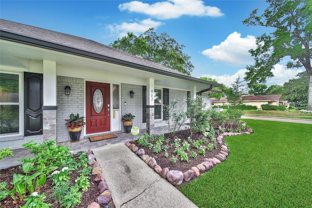 963 Thornton Rd, Houston, TX 77018 - property entrance with brick siding, a lawn, covered porch, and roof with shingles