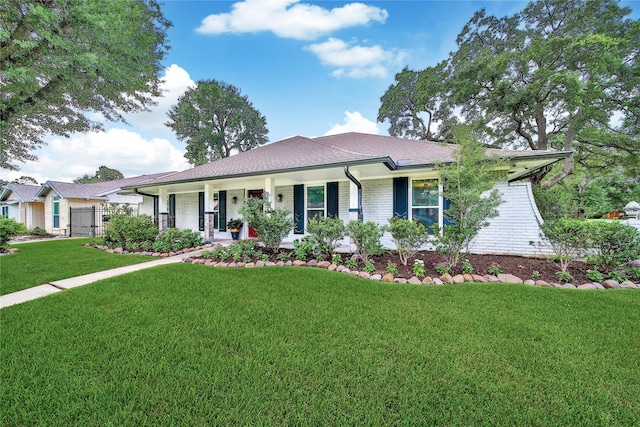 963 Thornton Rd, Houston, TX 77018 - single story home with a front lawn, covered porch, brick siding, and roof with shingles