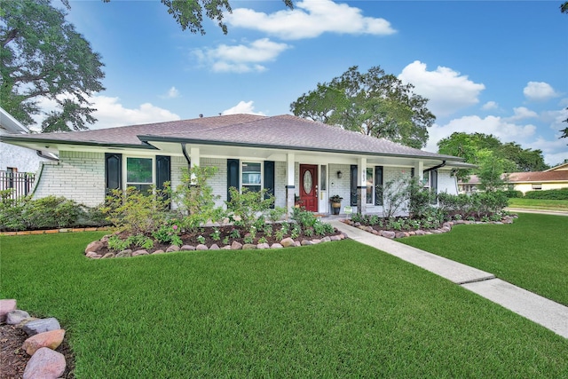 963 Thornton Rd, Houston, TX 77018 - ranch-style home with a porch, a front yard, brick siding, and roof with shingles