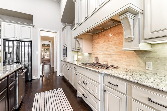 27511 Becketts Knoll Ct, Katy, TX 77494 - kitchen with stainless steel appliances, light stone counters, dark wood-type flooring, baseboards, and backsplash