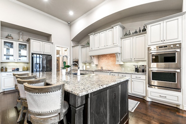 27511 Becketts Knoll Ct, Katy, TX 77494 - kitchen featuring stainless steel appliances, ornamental molding, a sink, tasteful backsplash, and a large island