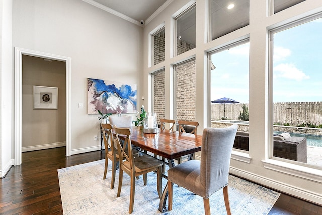 27511 Becketts Knoll Ct, Katy, TX 77494 - dining area with crown molding, dark wood finished floors, baseboards, and a high ceiling