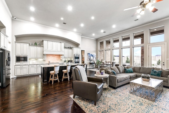 27511 Becketts Knoll Ct, Katy, TX 77494 - living area featuring crown molding, a high ceiling, dark wood finished floors, and ceiling fan