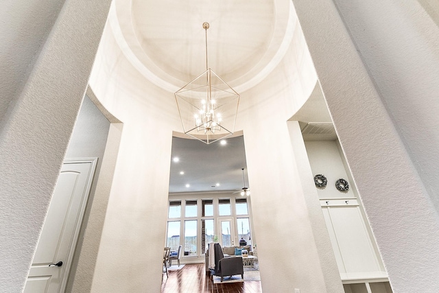 27511 Becketts Knoll Ct, Katy, TX 77494 - corridor with a chandelier, wood finished floors, a high ceiling, a textured wall, and crown molding