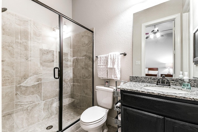 27511 Becketts Knoll Ct, Katy, TX 77494 - bathroom featuring vanity, toilet, a stall shower, ensuite bath, and a textured wall