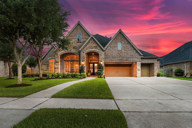 27511 Becketts Knoll Ct, Katy, TX 77494 - french country home with stone siding, concrete driveway, a front lawn, and brick siding
