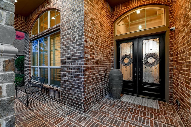 27511 Becketts Knoll Ct, Katy, TX 77494 - view of exterior entry with french doors, brick siding, and a security system