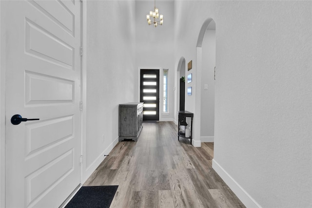 11930 Mccallister Run Dr, Humble, TX 77346 - entryway featuring arched walkways, wood finished floors, baseboards, and a chandelier