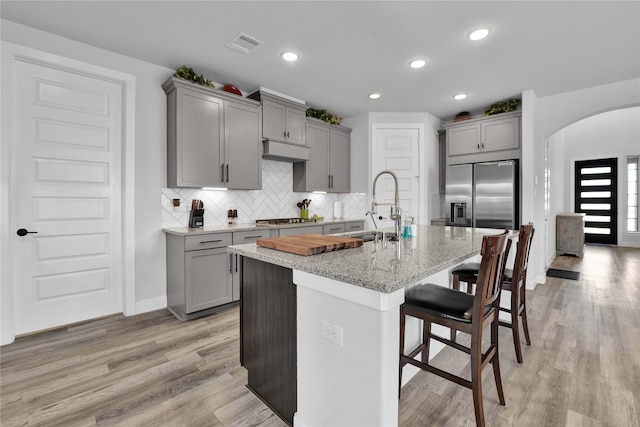11930 Mccallister Run Dr, Humble, TX 77346 - kitchen featuring gray cabinets, stainless steel appliances, arched walkways, and recessed lighting