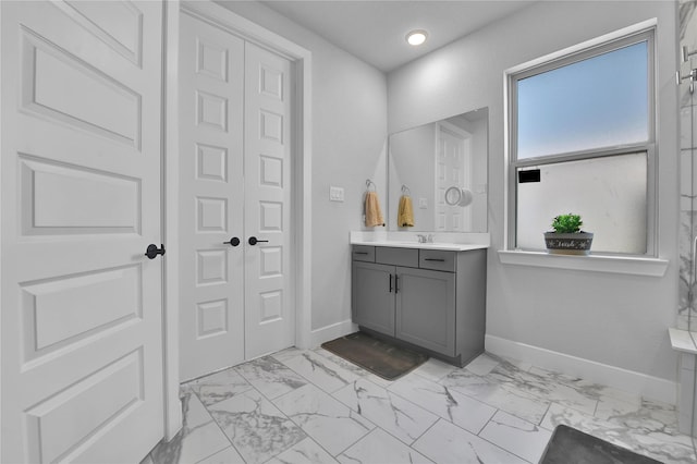 11930 Mccallister Run Dr, Humble, TX 77346 - bathroom with vanity, marble look tile flooring, baseboards, and recessed lighting