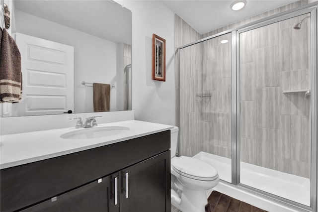 11930 Mccallister Run Dr, Humble, TX 77346 - bathroom featuring vanity, a shower stall, toilet, and wood finished floors