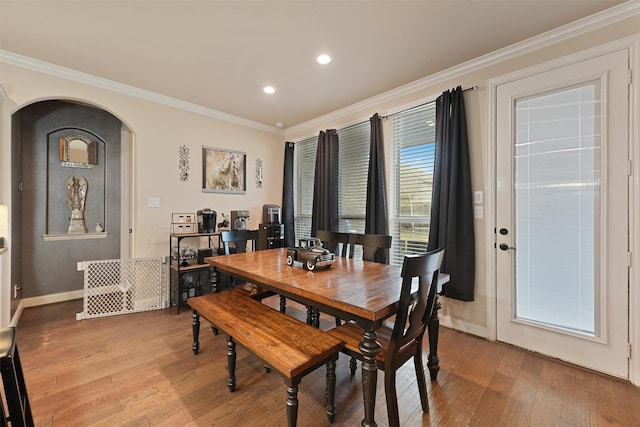 18110 Berry Garden Ln, Spring, TX 77379 - dining area featuring arched walkways, light wood-type flooring, ornamental molding, recessed lighting, and baseboards