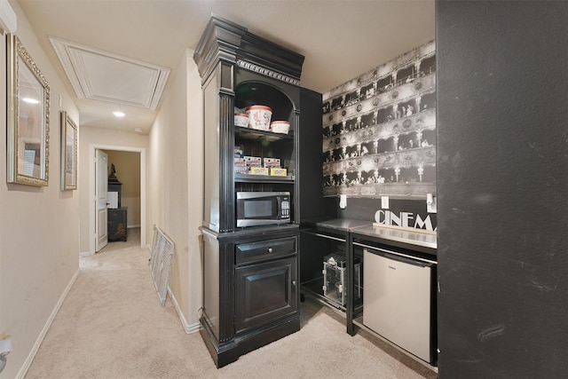 18110 Berry Garden Ln, Spring, TX 77379 - bar area featuring stainless steel microwave, light colored carpet, refrigerator, and baseboards