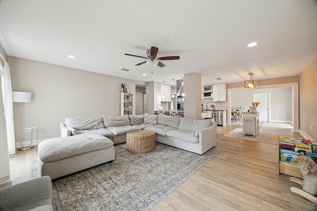 15818 Acapulco Dr, Jersey Village, TX 77040 - living room featuring light wood-style flooring, ceiling fan, recessed lighting, and baseboards