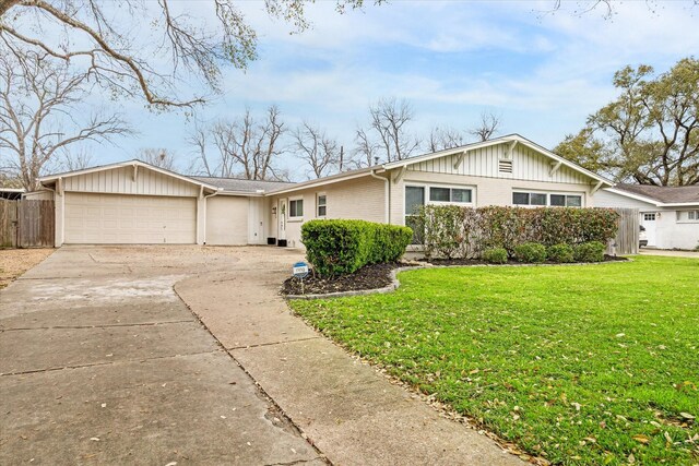 15818 Acapulco Dr, Jersey Village, TX 77040 - view of front of property featuring an attached garage, board and batten siding, concrete driveway, and brick siding