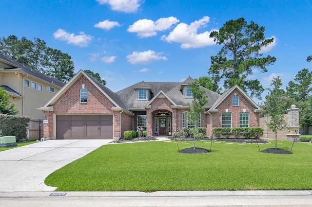 16923 Fondness Park Dr, Spring, TX 77379 - traditional-style house featuring brick siding, a front lawn, concrete driveway, and roof with shingles